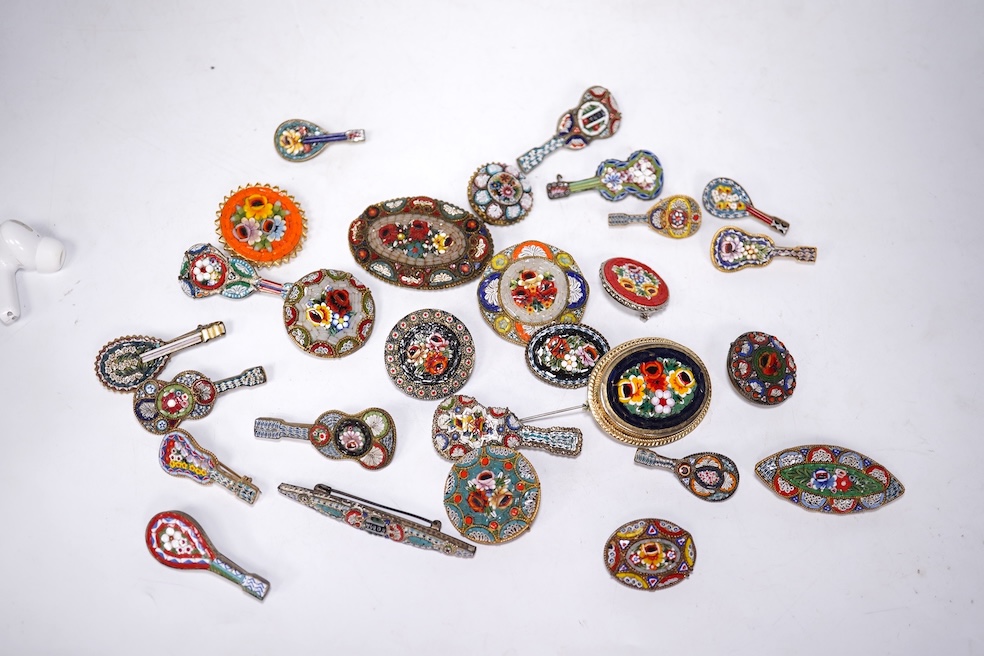 A collection of twenty-eight brooches, including fourteen mixed guitar and banjo shaped brooches, six large oval brooches, seven smaller brooches and one small oval., Condition - good